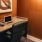a desk with a chair and a painting on the wall